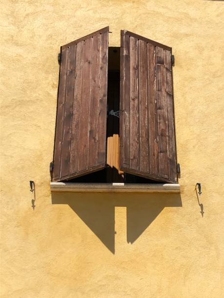 istock Brown Shutters Yellow House 1166229289