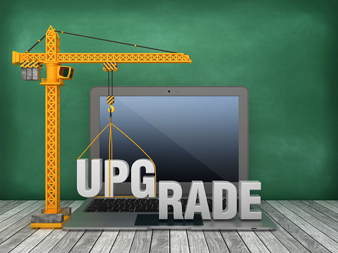 Tower Crane and Laptop with UPGRADE Word on Chalkboard Background - 3D Rendering