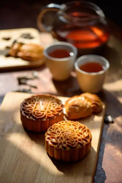 Image of Chinese traditional festival mid-autumn Moon cake and Tea. Chinese word on moon cake mean lotus seed paste and Jade Pandan paste.