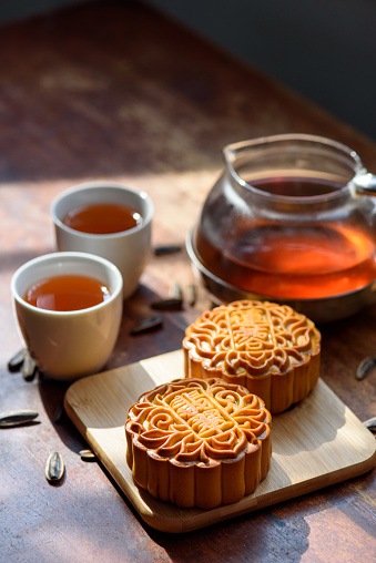 Image of Chinese traditional festival mid-autumn Moon cake and Tea. Chinese word on moon cake mean lotus seed paste and Jade Pandan paste.