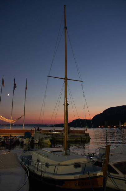 istock Sail boat at docks after sunset blue hour sky in Italy 1166230543