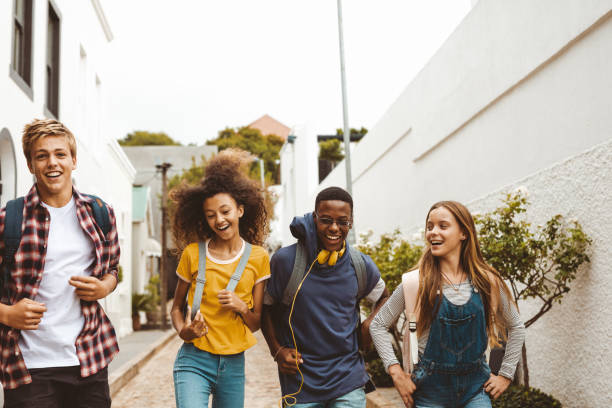 istock Friends having fun walking in the street 1166230544