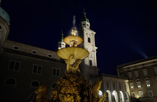 the Fraumuenster church in Zurich at night in the moonlight, the Limmat river, mirrors and reflections in the water, romantic view of the old town of Zurich