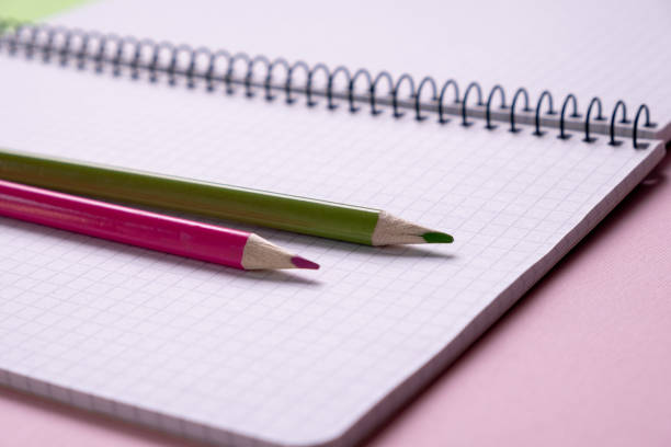 istock top view of a open  school notebook  with a spiral spring, office notepad in diagonal with  pencil 1166240580