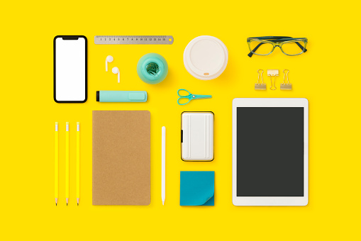 Things on my desk flat lay. Back to school flat lay on yelow background.
