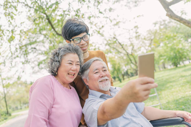 istock senior Asian man using smartphone for selfie with his family 1166243933