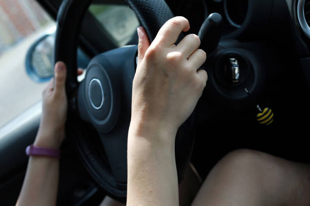 istock Person driving car 1166244337