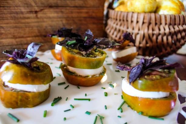 istock Delicious looking fresh Caprese Salad stacks made with Heirloom tomatoes fresh mozzarella and purple basil drizzled with balsamic reduction 1166245662