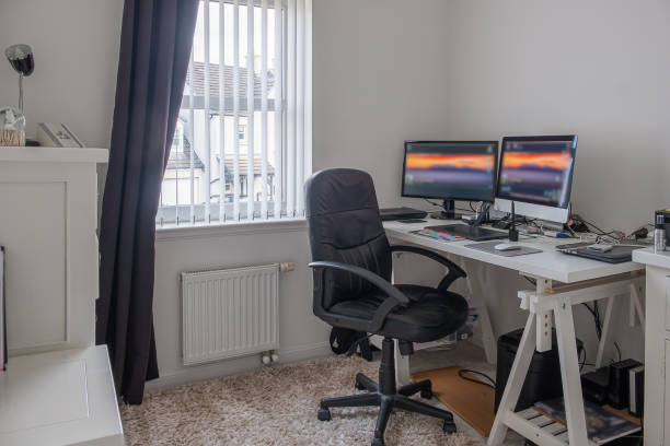 istock Work from Home Office with Twin Monitors Tablet Mouse computor hard drives on white painted table. 1166245900