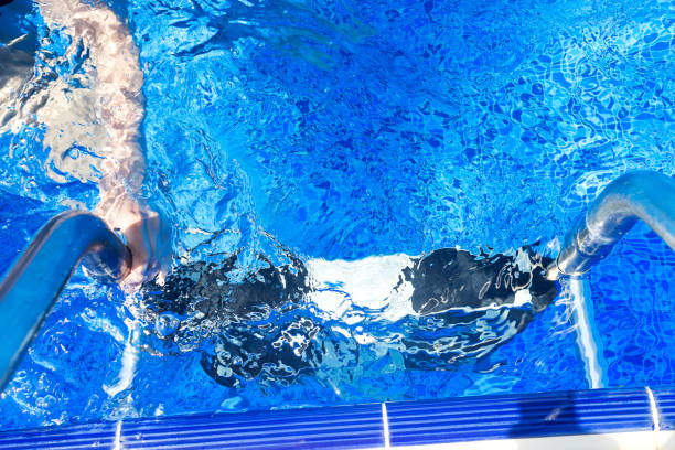 istock Female's hand holding a handrail in a swimming pool 1166246884