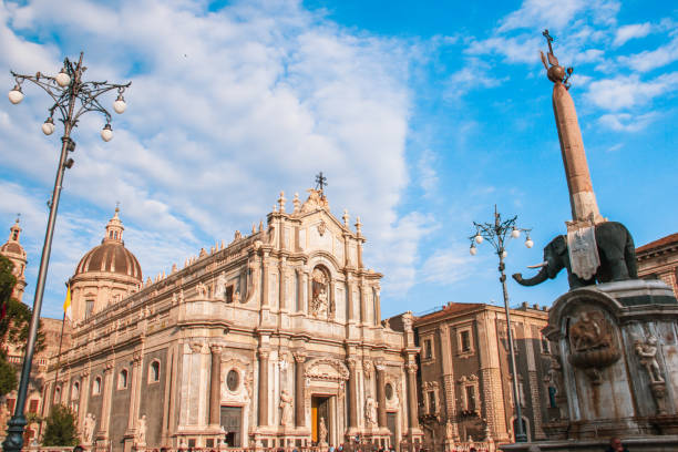 Catania Sicily Italy 2019 Cathedral square side view with the historic monument of lava stone elephant statue with old obelisk, baroque architecture Catania Cathedral square side view with the historic monument of lava stone elephant statue with old obelisk, baroque architecture Catania elephant figurine stock pictures, royalty-free photos & images