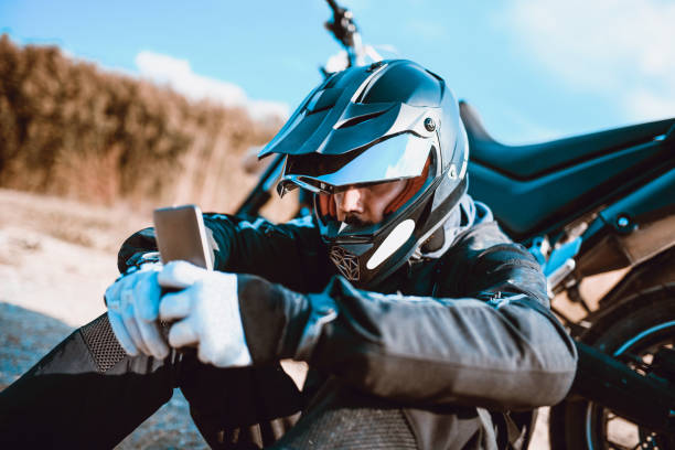 istock Male Biker Looking On A Mobile Map To Find Desired Location 1166253490