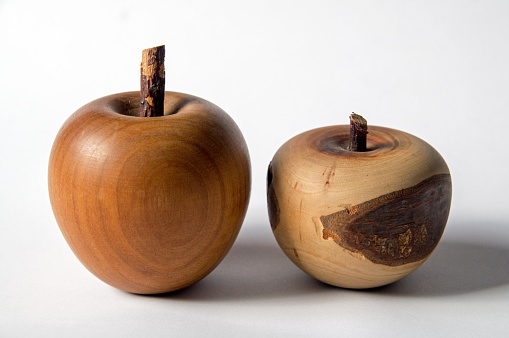 a likeness of an apple made of wood