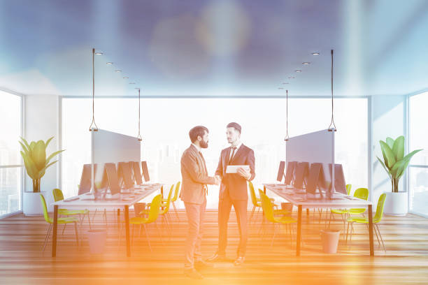 istock Men shaking hands in green open space office 1166255504