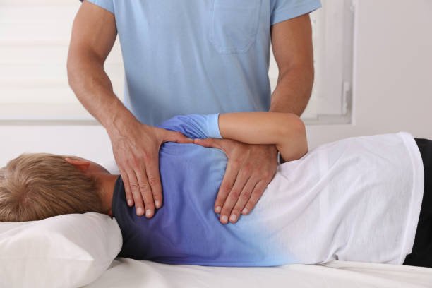 istock Boy having chiropractic back adjustment. Osteopathy, Physiotherapy and Kinesiology for children. Bad posture correction 1166255646