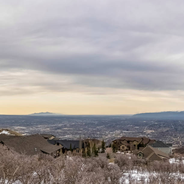 istock Square frame Panoramic view of a valley amd mountain under vast cloud filled sky in winter 1166257243