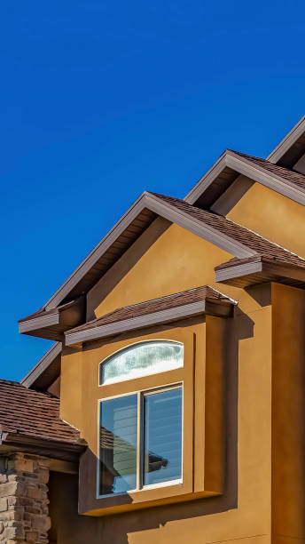 istock Vertical frame Home with concrete and stone exterior wall against clear blue sky on a sunny day 1166257535