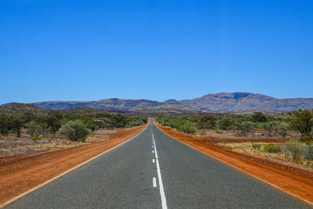 istock Perfect straight road between red dust at Karijini National Park 1166258283