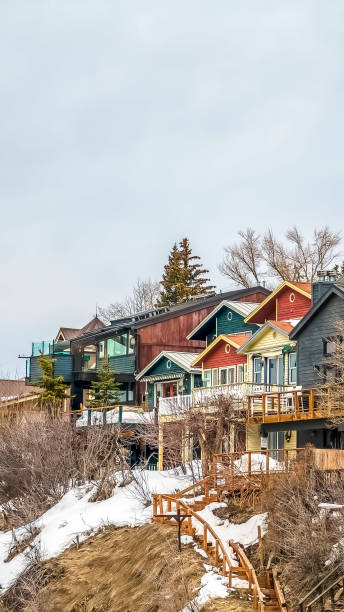 istock Vertical Homes with balconies on a mountain against sky filled with clouds in winter 1166258406