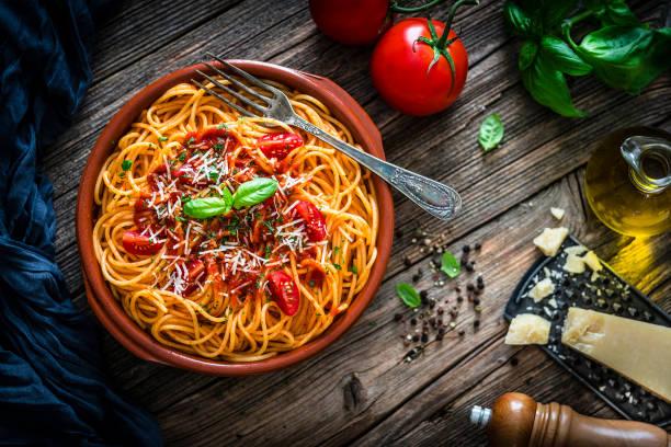 istock Spaghetti with tomato sauce shot on rustic wooden table 1166258450