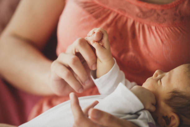 istock Newborn baby holding mother's finger 1166259648