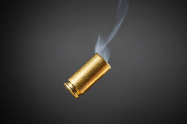 smoking bullet casing smoking bullet casing just fired out of a handgun tumbling through the air armory photos stock pictures, royalty-free photos & images