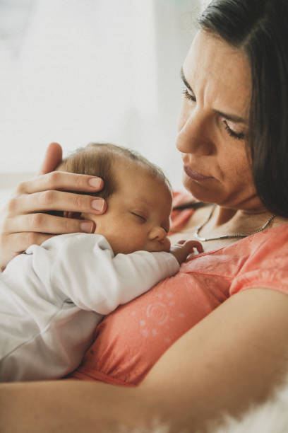 istock Mom and sleeping baby 1166260100