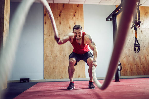 istock Men with rope in functional training fitness 1166260370