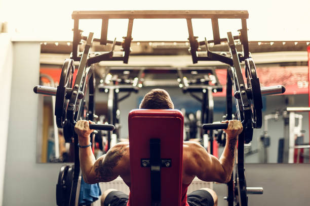istock Man doing an exercise for the shoulders in the simulator 1166261558