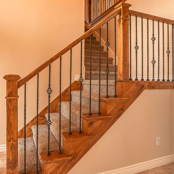 istock Square frame Carpeted stairs with wood handrail and metal railing inside an empty new home 1166261596