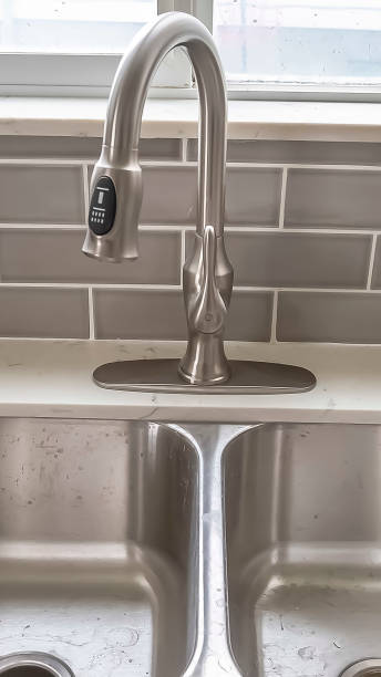 istock Vertical frame Double bowl stainless steel sink undermounted on the white kitchen countertop 1166262217
