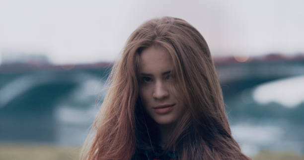 istock Young woman flirting with camera. Summer cityscape 1166262682