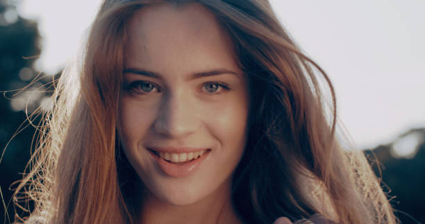 istock Young woman flirting with camera. Summer park scenery 1166262756