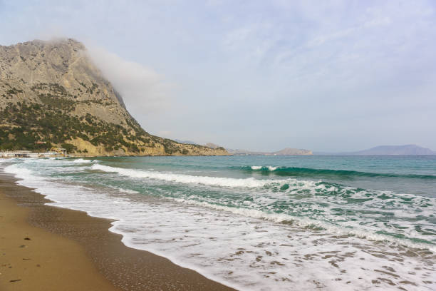 Turquoise black sea cold spring day. Fog. The moon
