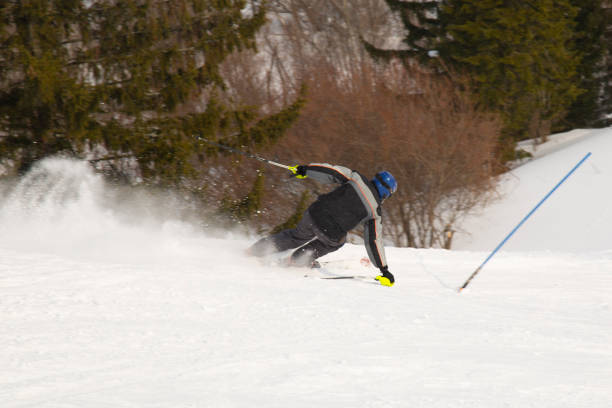 Syktyvkar, Komi/ Russia, March 15, 2019 / Skier on the hillside riding at high speed.