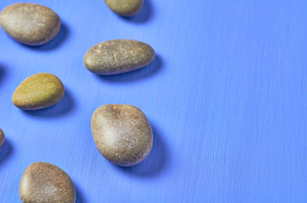 istock Scattered gravel stones on blue scratched concrete. Space for text 1166263017