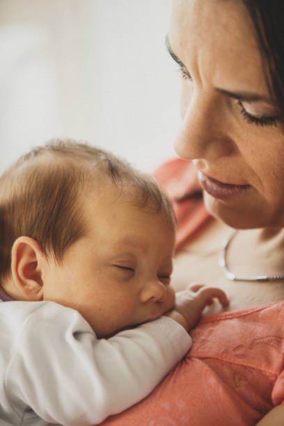 istock Newborn baby sleeping on mom's chest 1166263204