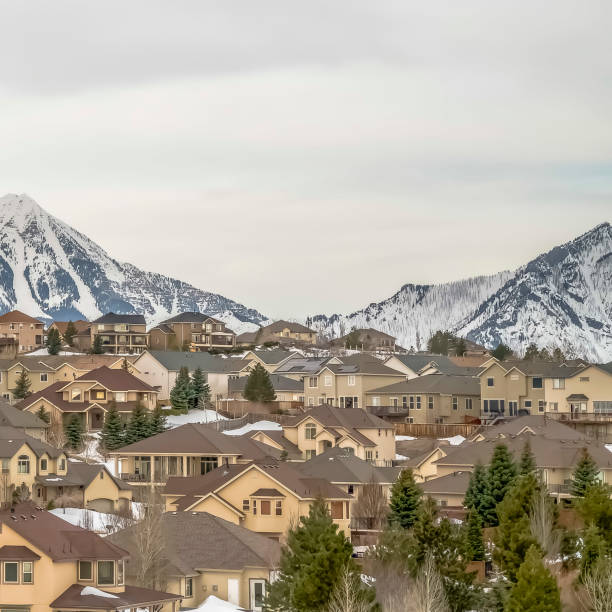 istock Square Residences and towering mountain under bright cloudy sky viewed in winter 1166263298