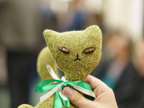 istock Green toy kitten in the child hand. 1166263483