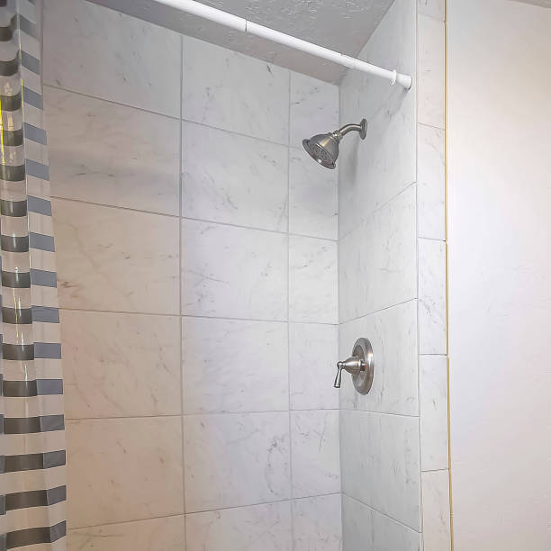 istock Square frame Stand alone sink toilet and shower inside a small bathrrom with white wall 1166264117