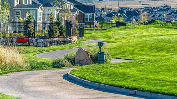 istock Panorama Narrow paved road that winds through vast grassy terrain viewed on a sunny day 1166264341