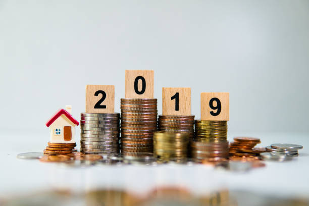 istock Miniature house on wooden block year 2019 1166264349