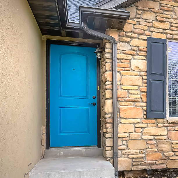 istock Square frame Home with stairs blue front door stone wall and windows with wooden shutters 1166264796