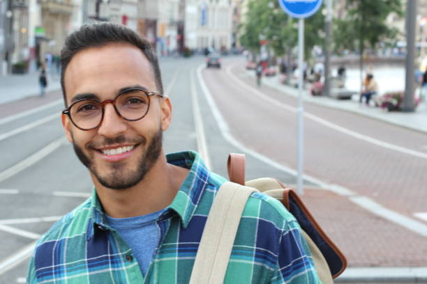 istock Cute Latino man smiling outdoors 1166265056