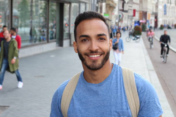 istock Handsome ethnic young male smiling outdoors 1166265201