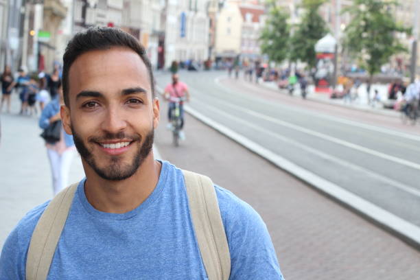 istock Cute ethnic bearded man smiling outdoors 1166265213