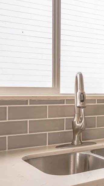 istock Vertical Undermount double bowl sink and faucet on the gleaming white kitchen countertop 1166265722