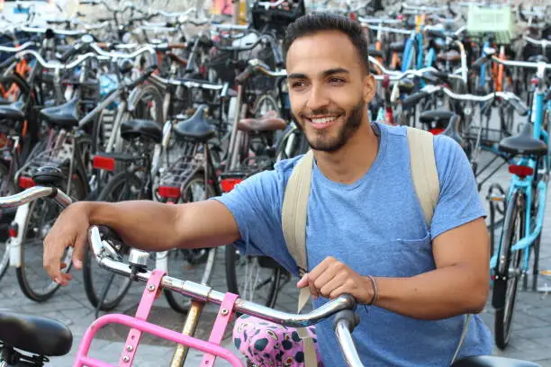 Vector illustration of Handsome ethnic man in bicycle parking lot