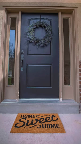 istock Vertical vertical, tall, magazine, vertical, tall, magazine, frame Wreath and doormat on the front door with sidelights and transom window 1166266356