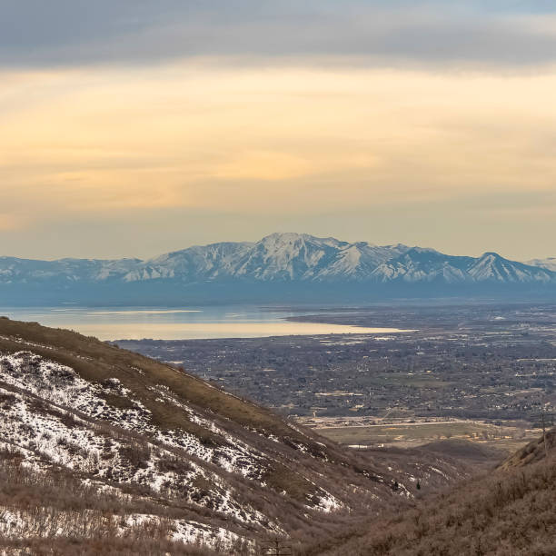 istock Square Lake and vast valley viewed from a mountain with trees and snow 1166267031